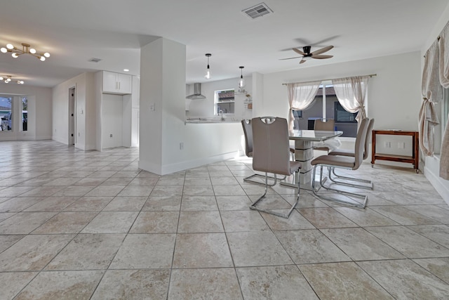 dining room featuring baseboards, a ceiling fan, visible vents, and light tile patterned floors