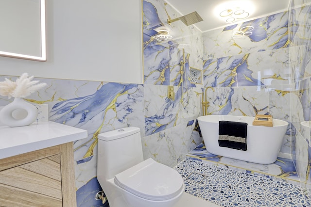 bathroom with vanity, toilet, a soaking tub, and tile walls