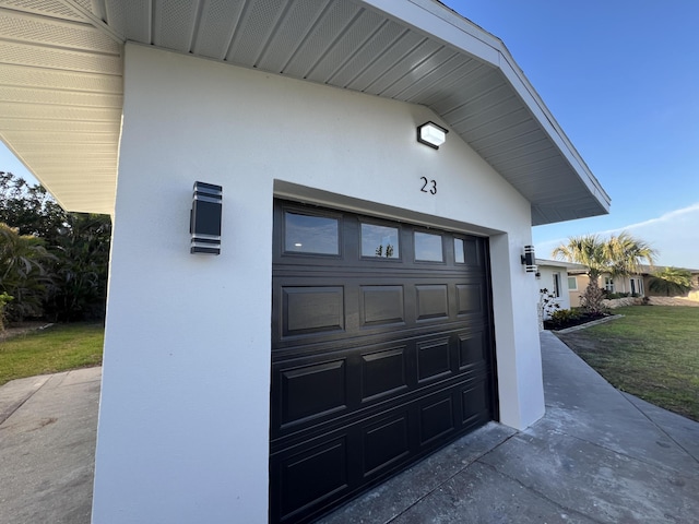 garage featuring concrete driveway
