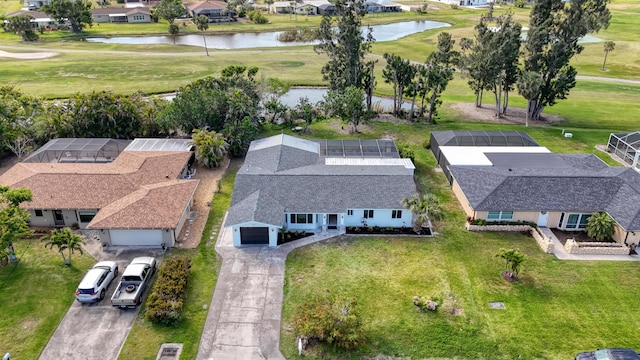 aerial view with view of golf course, a water view, and a residential view