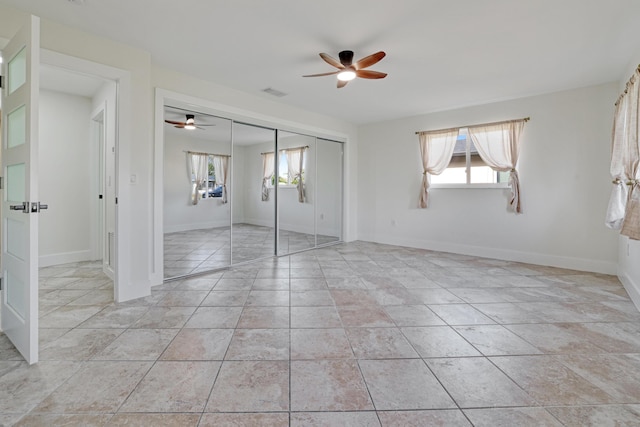unfurnished bedroom with a ceiling fan, visible vents, a closet, and multiple windows