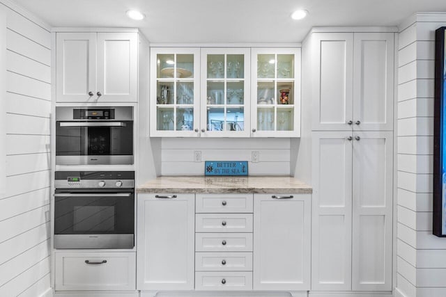 2917 S Ocean Blvd Unit 104, Highland Beach, FL 33487 - kitchen with white cabinets, glass insert cabinets, double oven, light stone counters, and recessed lighting