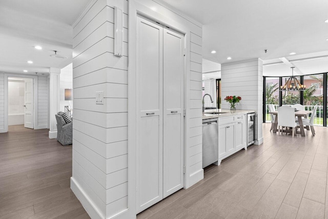 2917 S Ocean Blvd Unit 104, Highland Beach, FL 33487 - kitchen with dishwasher, wine cooler, recessed lighting, a chandelier, and white cabinets