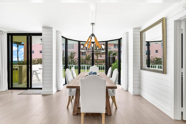 2917 S Ocean Blvd Unit 104, Highland Beach, FL 33487 - dining area with a chandelier, wood finished floors, and expansive windows