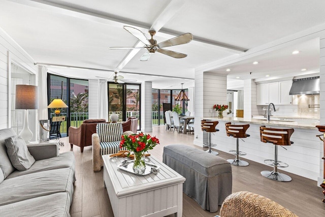 2917 S Ocean Blvd Unit 104, Highland Beach, FL 33487 - living room with wood finished floors, a ceiling fan, and beamed ceiling