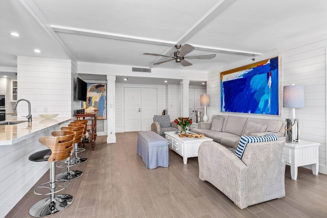 2917 S Ocean Blvd Unit 104, Highland Beach, FL 33487 - living room featuring ornate columns, ceiling fan, wood finished floors, recessed lighting, and wood walls