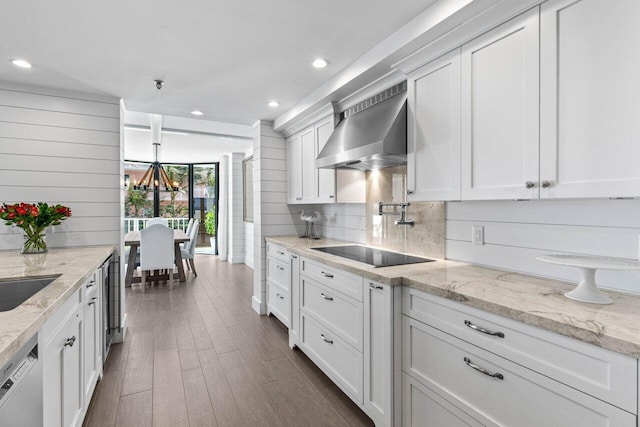 2917 S Ocean Blvd Unit 104, Highland Beach, FL 33487 - kitchen featuring wall chimney range hood, black electric stovetop, dishwashing machine, white cabinets, and backsplash