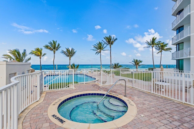 2917 S Ocean Blvd Unit 104, Highland Beach, FL 33487 - community pool featuring a community hot tub, a patio area, fence, and a water view