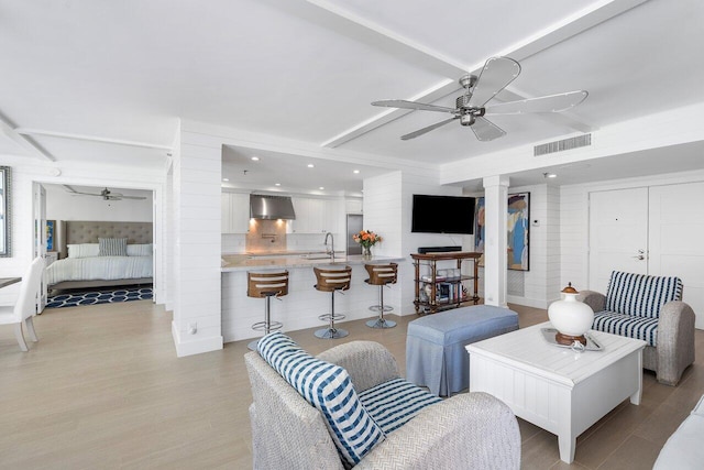 2917 S Ocean Blvd Unit 104, Highland Beach, FL 33487 - living room with a ceiling fan, decorative columns, light wood-style floors, and recessed lighting