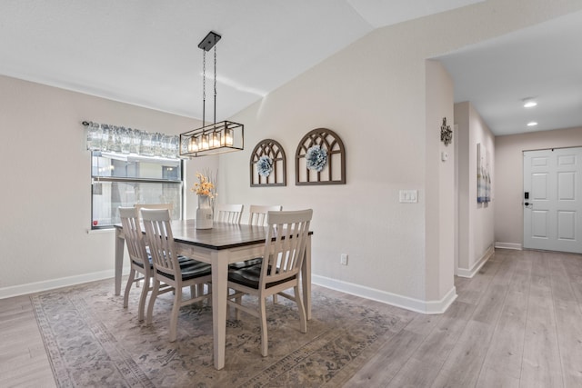14423 Dalia Ave, Fort Pierce, FL 34951 - dining room with light wood-type flooring, an inviting chandelier, baseboards, and vaulted ceiling