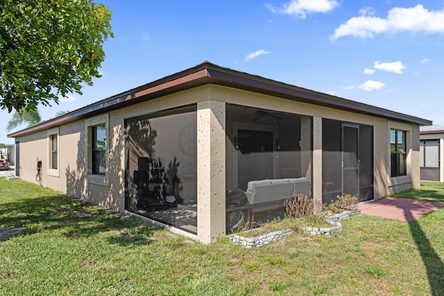 14423 Dalia Ave, Fort Pierce, FL 34951 - exterior space featuring stucco siding, a sunroom, and a lawn