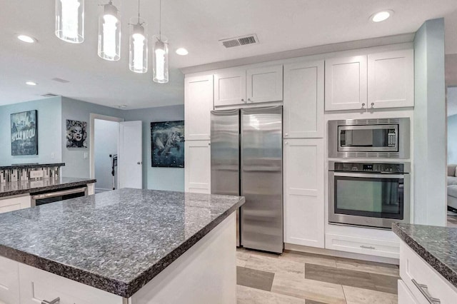 2416 NW 32nd St, Boca Raton, FL 33431 - kitchen with stainless steel appliances, a chandelier, white cabinetry, recessed lighting, and dark stone countertops