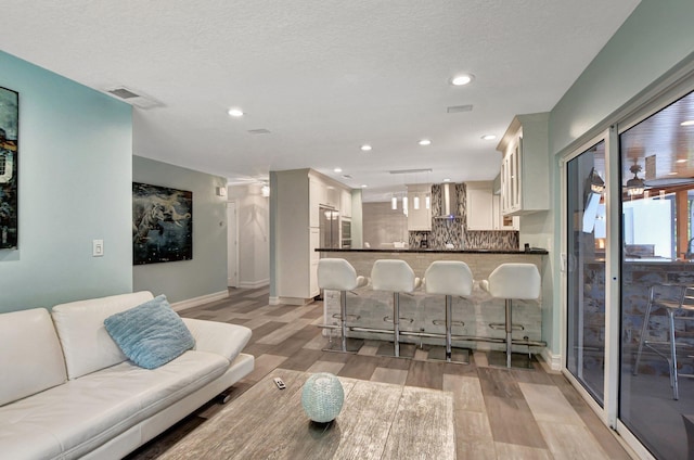 2416 NW 32nd St, Boca Raton, FL 33431 - living area featuring light wood-style floors, baseboards, and recessed lighting