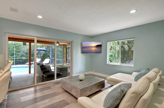 2416 NW 32nd St, Boca Raton, FL 33431 - living area featuring recessed lighting, a textured ceiling, and baseboards