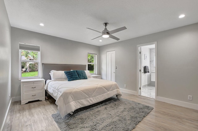 2416 NW 32nd St, Boca Raton, FL 33431 - bedroom featuring baseboards, light wood finished floors, recessed lighting, ensuite bathroom, and ceiling fan