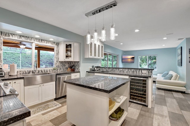 2416 NW 32nd St, Boca Raton, FL 33431 - kitchen featuring beverage cooler, dishwasher, open shelves, backsplash, and a sink