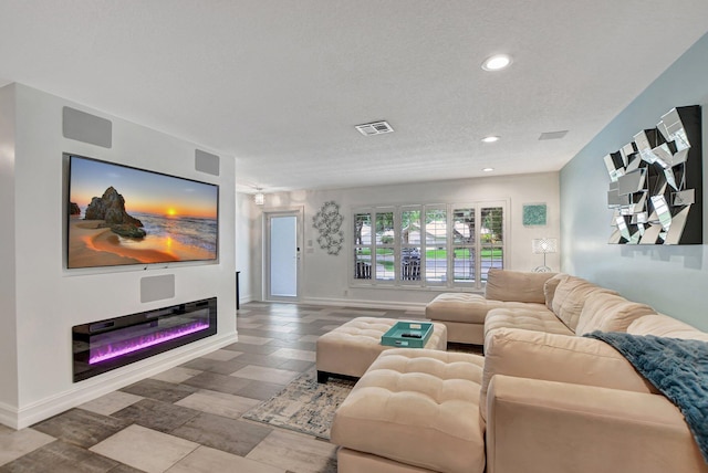 2416 NW 32nd St, Boca Raton, FL 33431 - living room with recessed lighting, baseboards, wood finished floors, a glass covered fireplace, and a textured ceiling