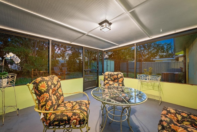 sunroom with outdoor dining area and finished concrete flooring