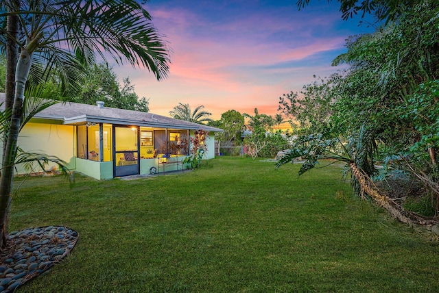 view of yard with fence and a sunroom