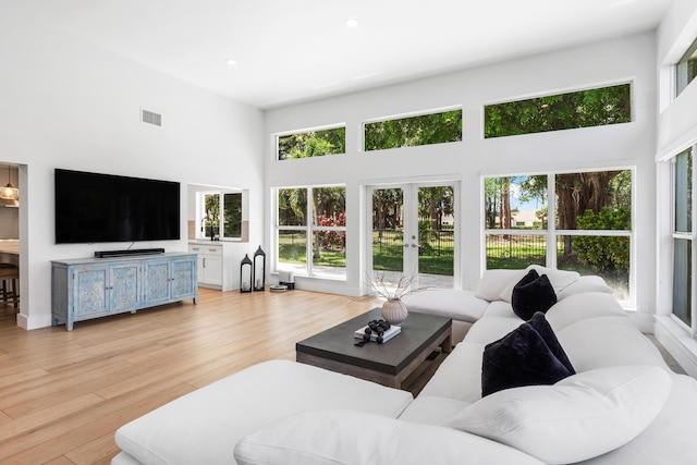 654 Lakewoode Cir W, Delray Beach, FL 33445 - living room featuring a towering ceiling, french doors, light wood-type flooring, and recessed lighting