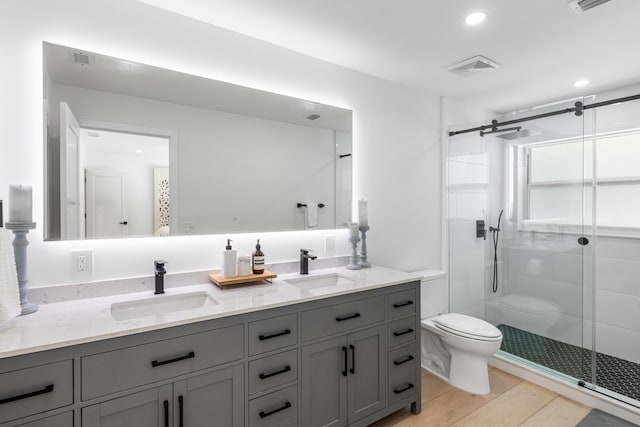 654 Lakewoode Cir W, Delray Beach, FL 33445 - full bath with double vanity, a stall shower, wood finished floors, and recessed lighting