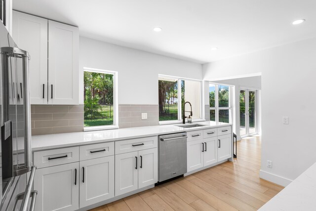 654 Lakewoode Cir W, Delray Beach, FL 33445 - kitchen with appliances with stainless steel finishes, backsplash, white cabinetry, light wood-style floors, and recessed lighting