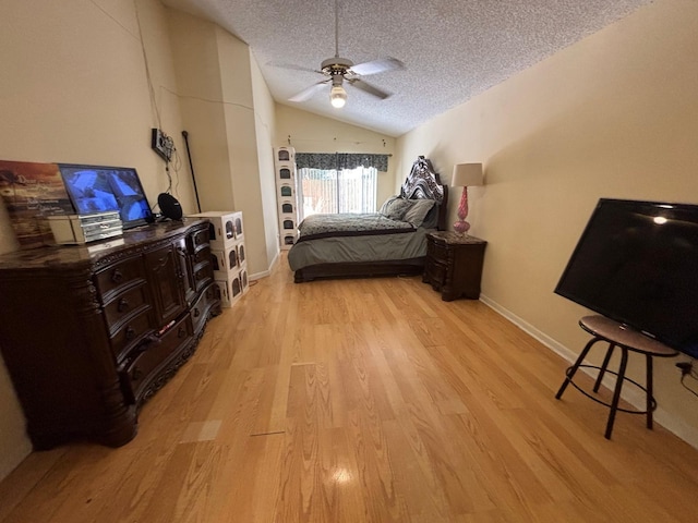 bedroom with baseboards, vaulted ceiling, light wood-style flooring, a textured ceiling, and a ceiling fan
