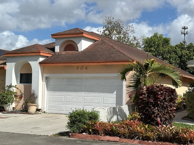 view of front of home featuring driveway, stucco siding, and an attached garage