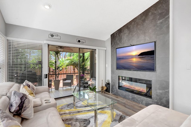 21687 Cromwell Cir, Boca Raton, FL 33486 - living area with an accent wall, wood finished floors, and a fireplace