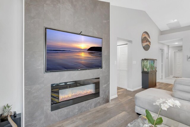 21687 Cromwell Cir, Boca Raton, FL 33486 - living room featuring lofted ceiling, a premium fireplace, baseboards, and wood finished floors