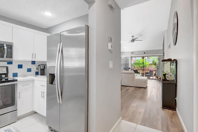 21687 Cromwell Cir, Boca Raton, FL 33486 - kitchen featuring open floor plan, ceiling fan, white cabinetry, light countertops, and appliances with stainless steel finishes