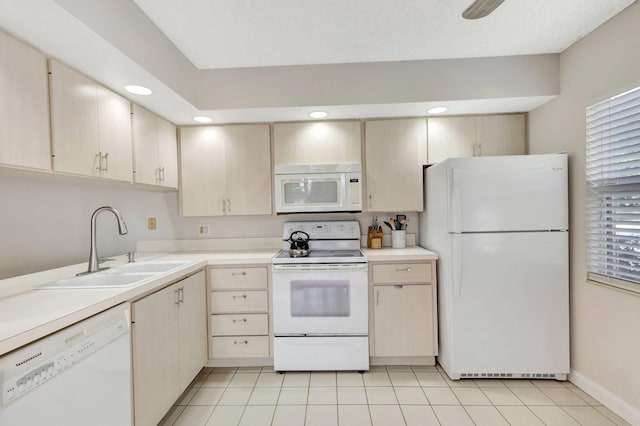 kitchen with light countertops, a sink, white appliances, and recessed lighting