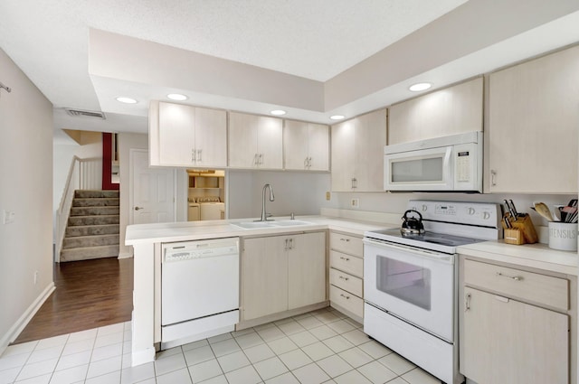 kitchen featuring a sink, visible vents, light countertops, and white appliances