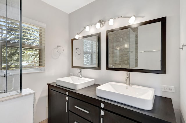 full bathroom featuring double vanity and a sink