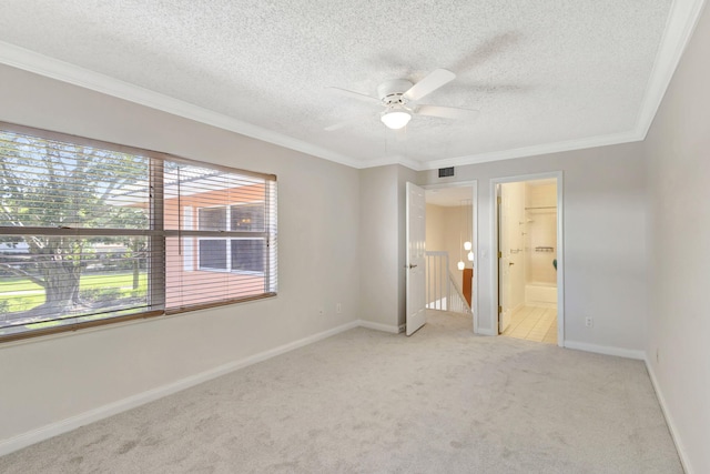 unfurnished bedroom with ensuite bathroom, carpet, a textured ceiling, ornamental molding, and baseboards
