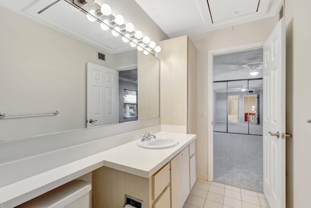 bathroom featuring vanity, tile patterned flooring, a textured ceiling, a ceiling fan, and visible vents