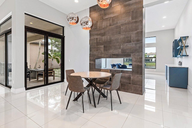 17165 Abruzzo Ave, Boca Raton, FL 33496 - dining room featuring an accent wall, light tile patterned floors, baseboards, and recessed lighting