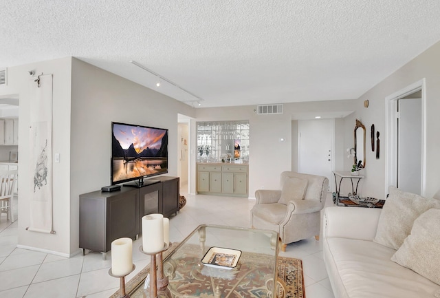 1625 Bridgewood Dr, Boca Raton, FL 33434 - living area with track lighting, a textured ceiling, light tile patterned floors, and visible vents