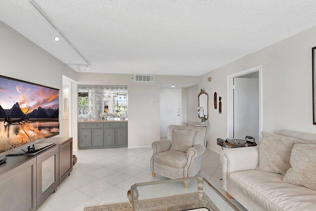 1625 Bridgewood Dr, Boca Raton, FL 33434 - living area with track lighting, light tile patterned floors, visible vents, and a textured ceiling