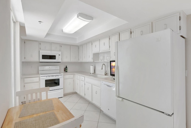 1625 Bridgewood Dr, Boca Raton, FL 33434 - kitchen with a sink, a tray ceiling, white appliances, light countertops, and light tile patterned flooring