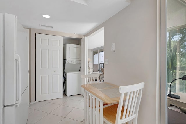 1625 Bridgewood Dr, Boca Raton, FL 33434 - dining room featuring light tile patterned flooring, stacked washer / drying machine, and visible vents