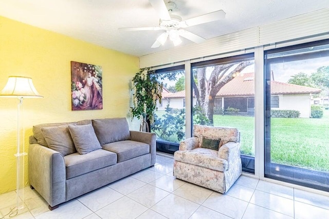 tiled living area with ceiling fan