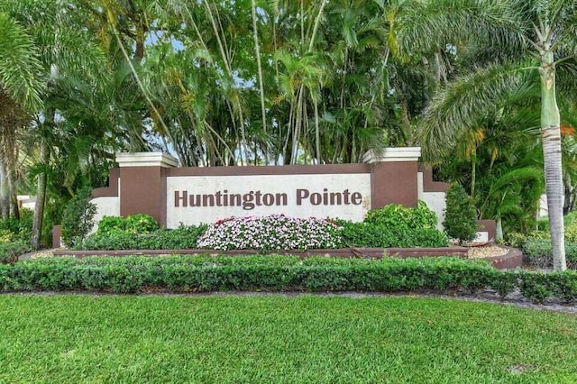 community / neighborhood sign with a lawn