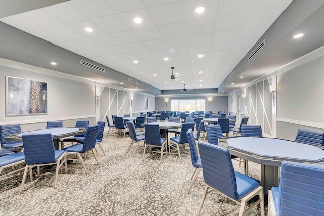 carpeted dining area with a tray ceiling, visible vents, and recessed lighting