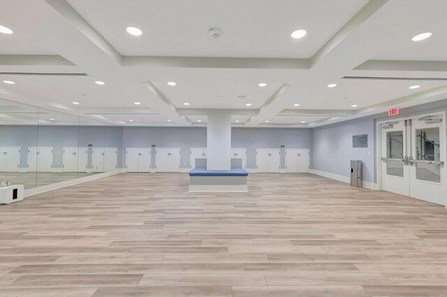 workout room featuring light wood-style floors, recessed lighting, french doors, and baseboards