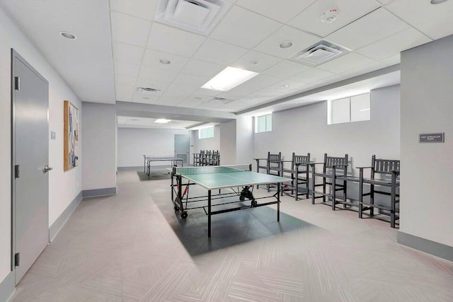 playroom with baseboards, a drop ceiling, and visible vents