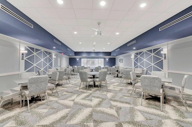 interior space with visible vents, an accent wall, carpet, and recessed lighting
