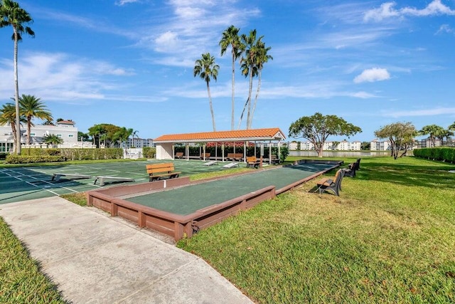 view of home's community featuring a lawn and shuffleboard