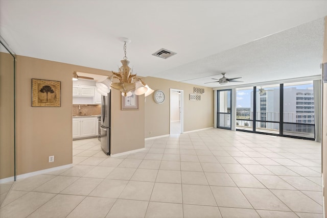 336 Golfview Rd Unit 916, North Palm Beach, FL 33408 - unfurnished room featuring a city view, baseboards, light tile patterned flooring, visible vents, and ceiling fan