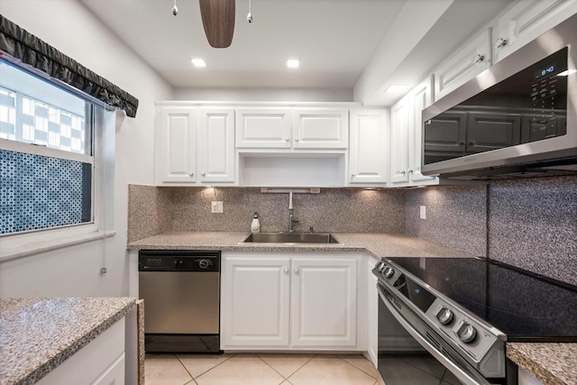 336 Golfview Rd Unit 916, North Palm Beach, FL 33408 - kitchen featuring stainless steel appliances, light tile patterned floors, a sink, and backsplash